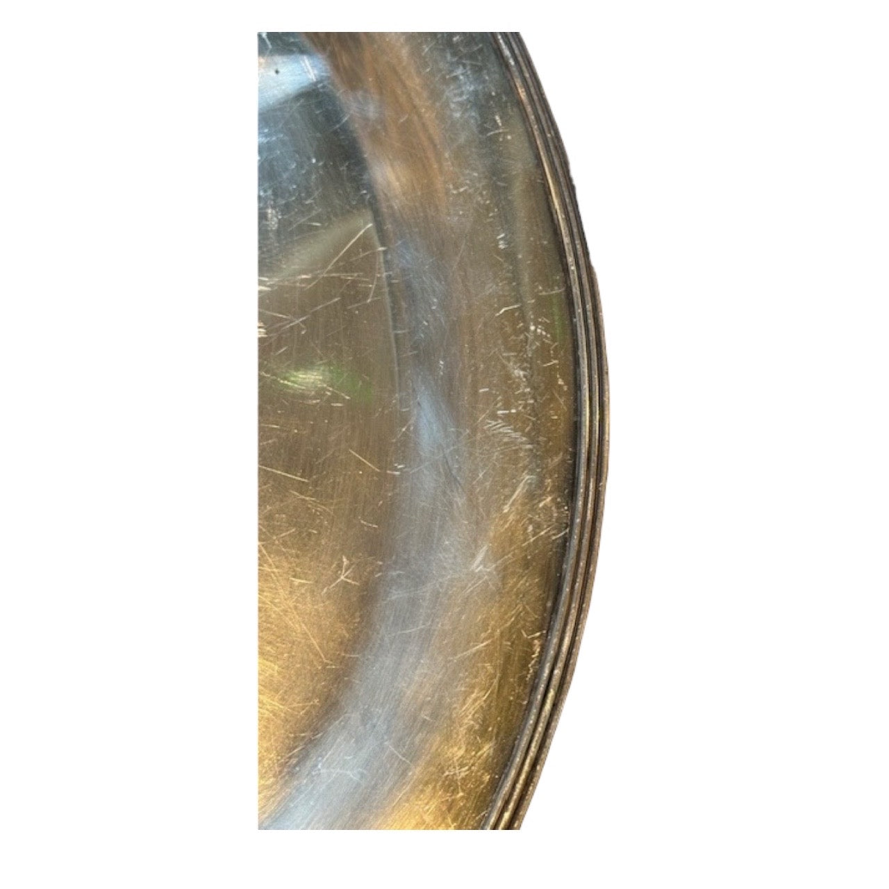 Close-up of the oval tray's well showing fine surface scratches and wear.