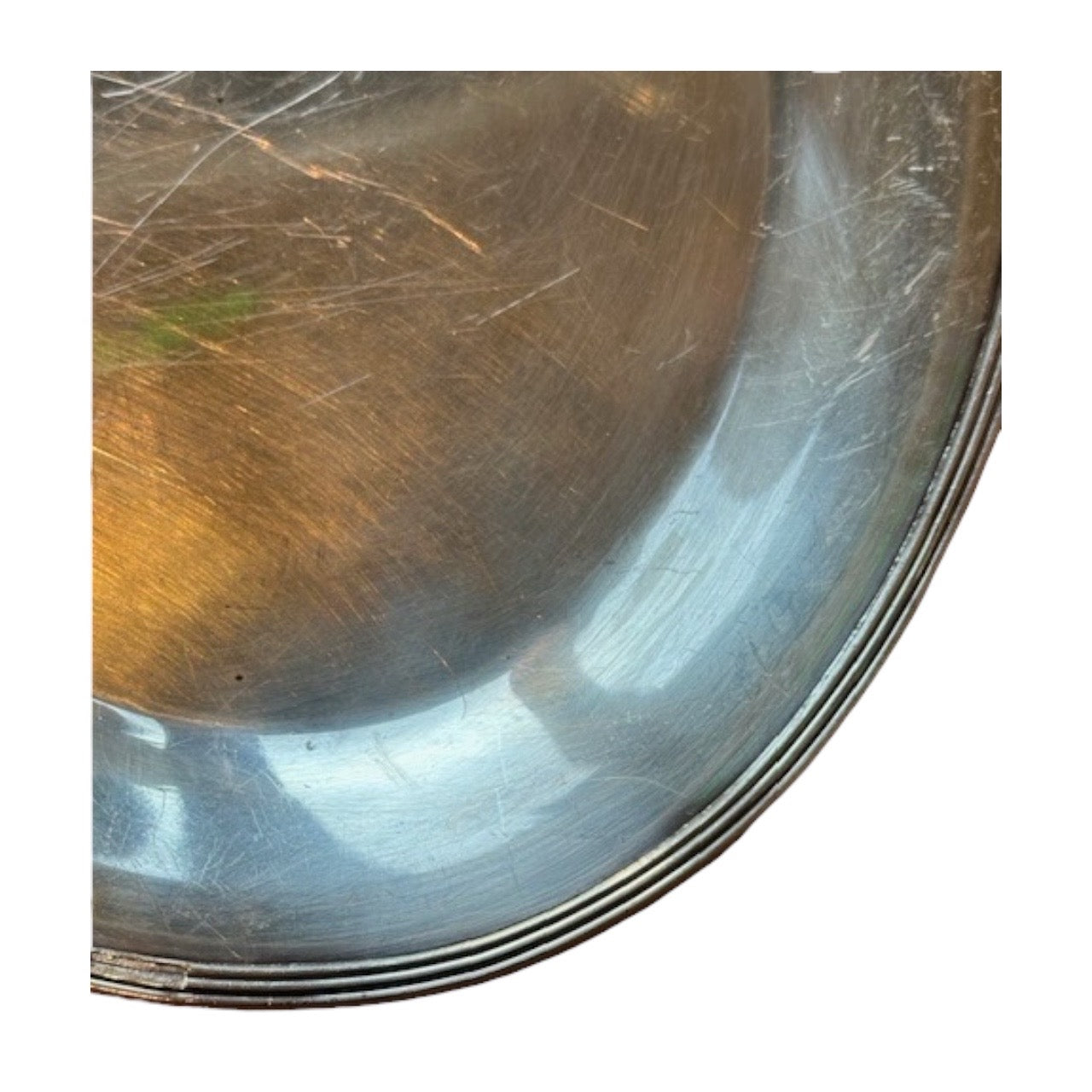 Detail of the oval tray's reeded rim and finely scratched silver-plate surface.