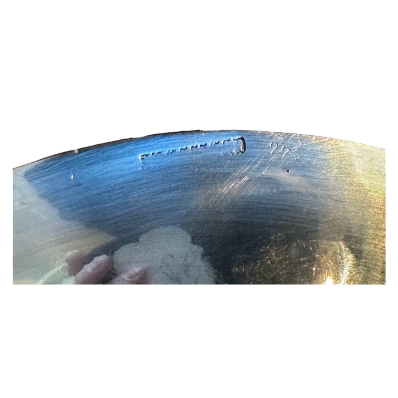 Close-up of maker's marks engraved on the underside rim of the oval silver-plate tray.
