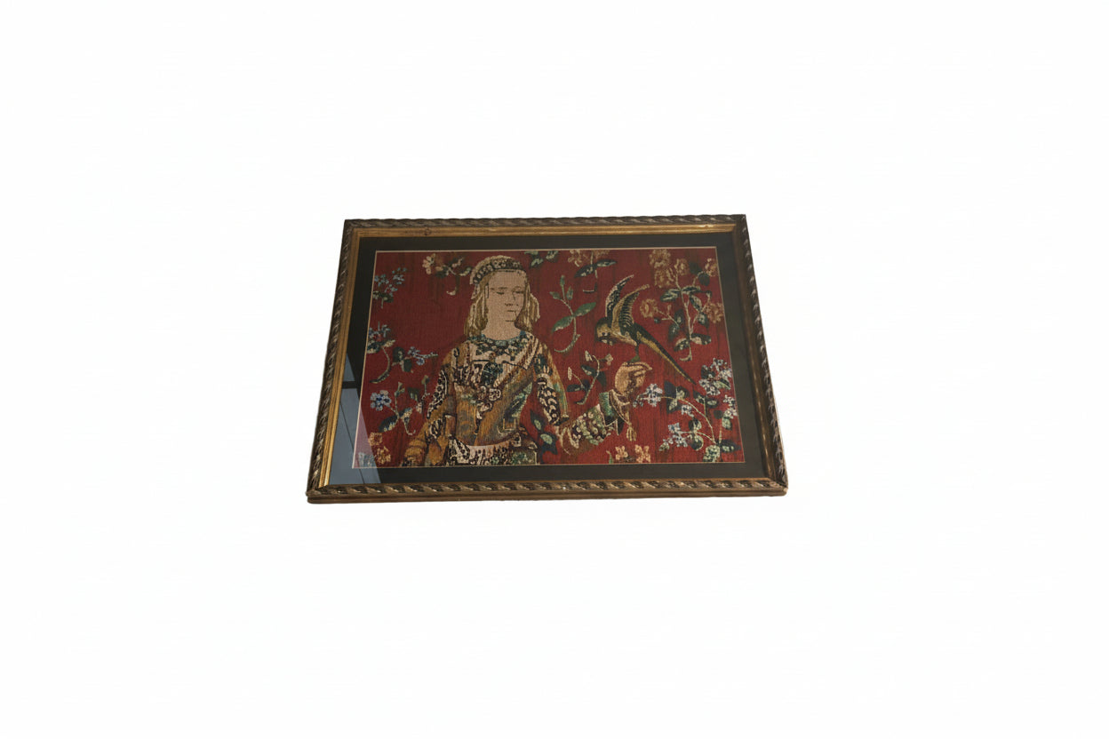 Restored framed needlepoint of a medieval lady with a bird, angled view in gilt frame