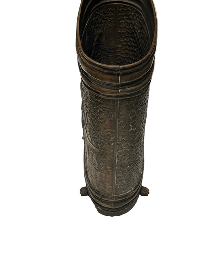 Tall view of oval brass umbrella stand standing on splayed paw feet