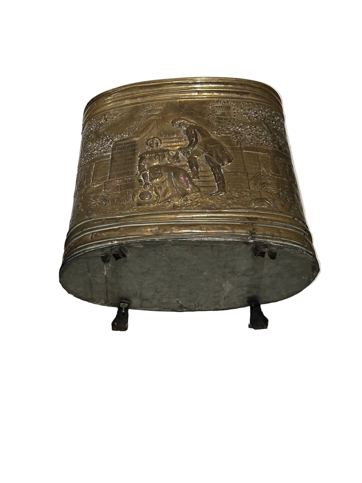 Angled top view of brass umbrella stand with embossed figural panel and paw feet