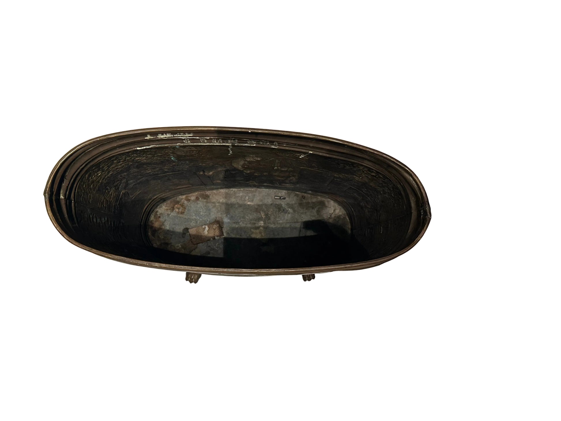 Top-down view into the oval brass umbrella stand showing galvanized metal liner