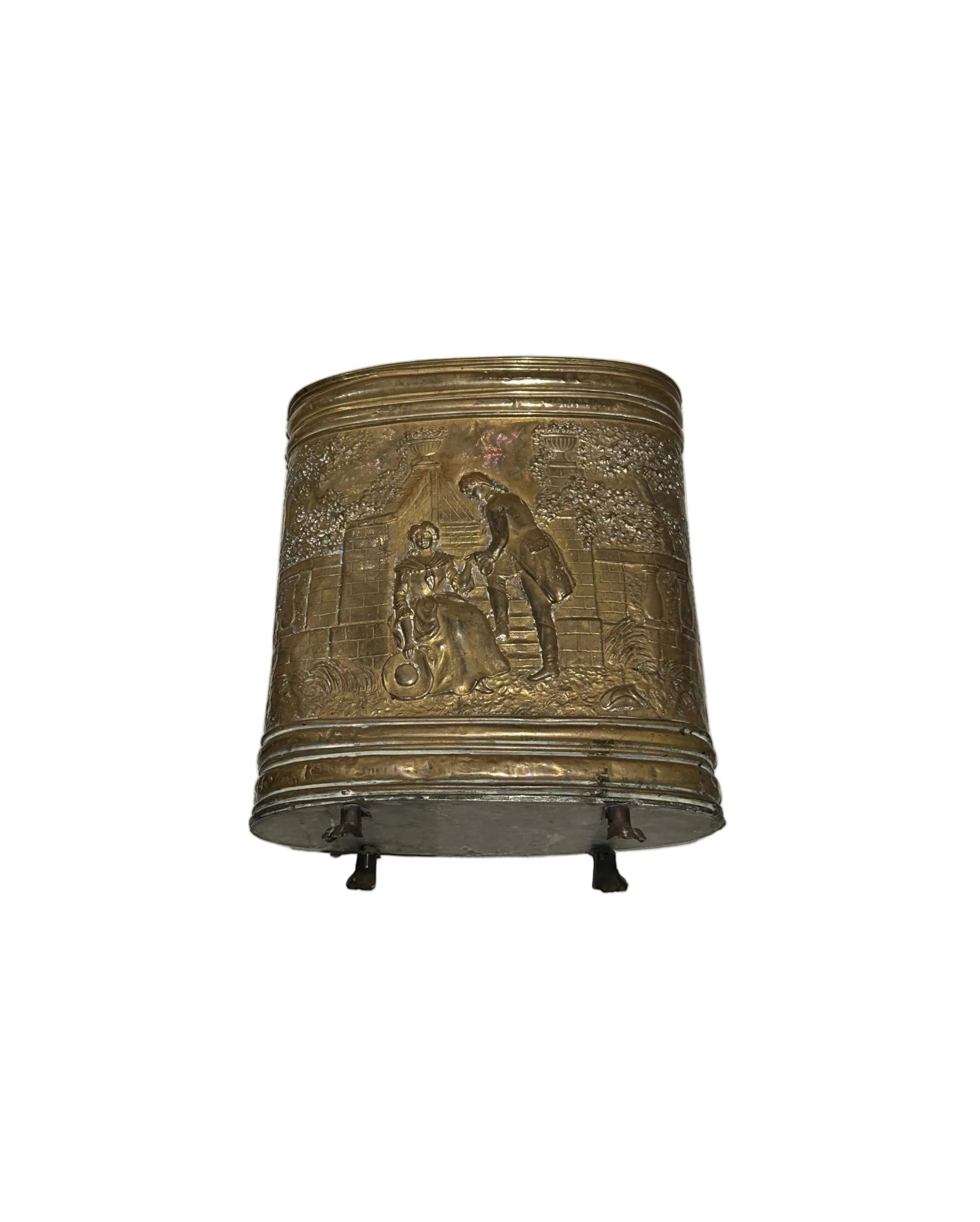 Embossed brass oval umbrella stand with figural courting-scene relief on paw feet