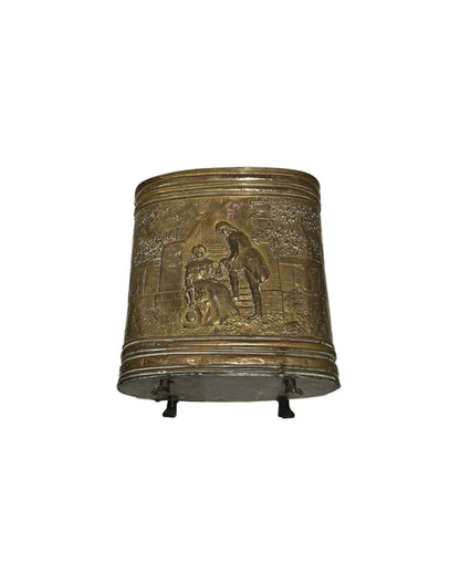 Embossed brass oval umbrella stand with figural courting-scene relief on paw feet