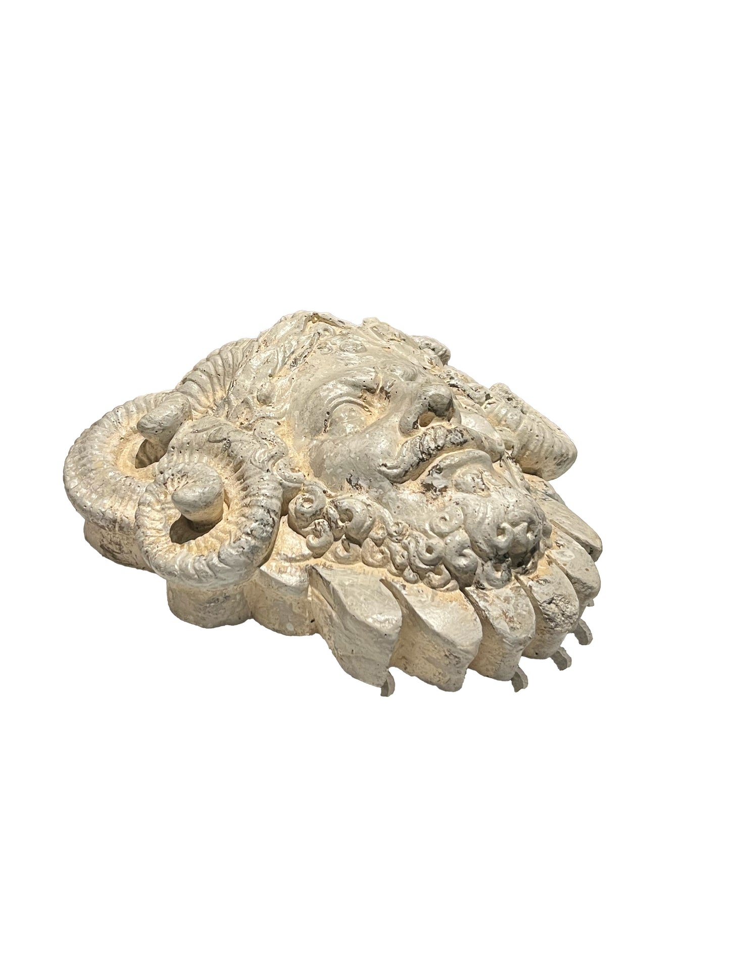 Cast concrete mascaron, three-quarter side view showing coiled ram's horns and beard.