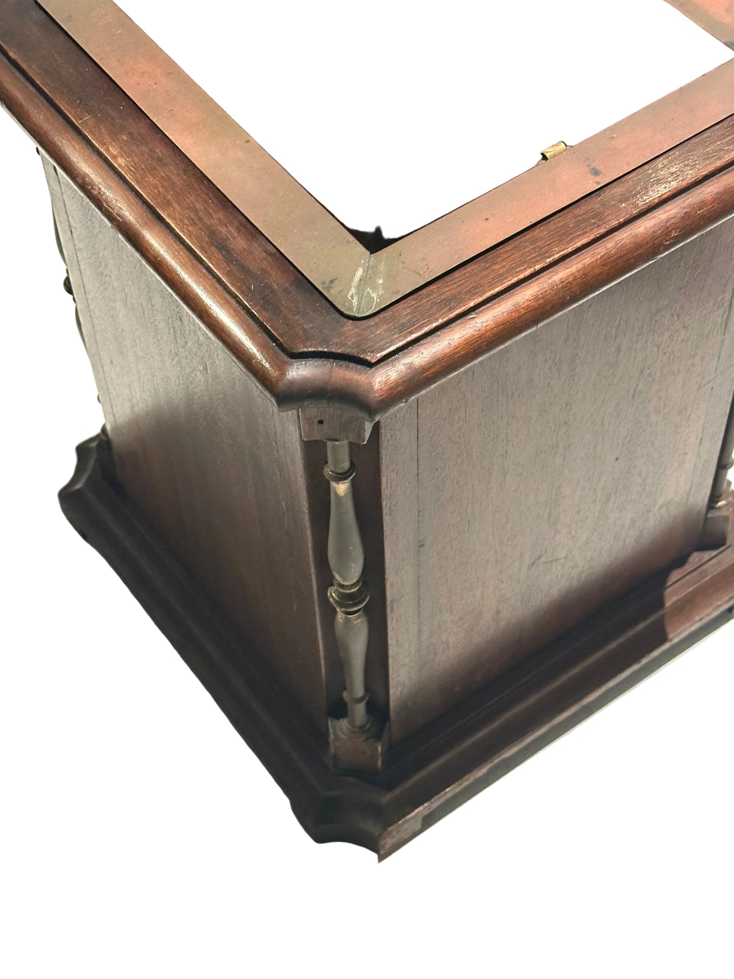 Corner detail of mahogany umbrella stand with turned spindle column and molded base