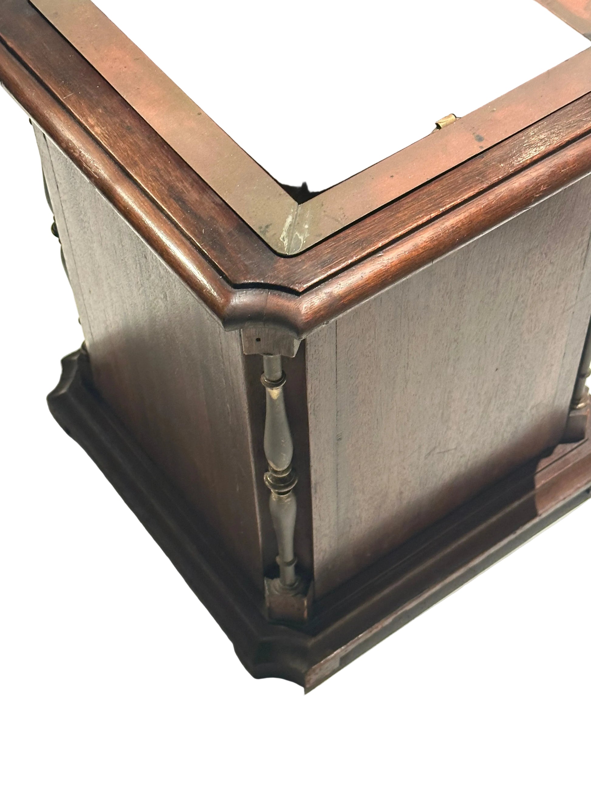 Corner detail of mahogany umbrella stand with turned spindle column and molded base