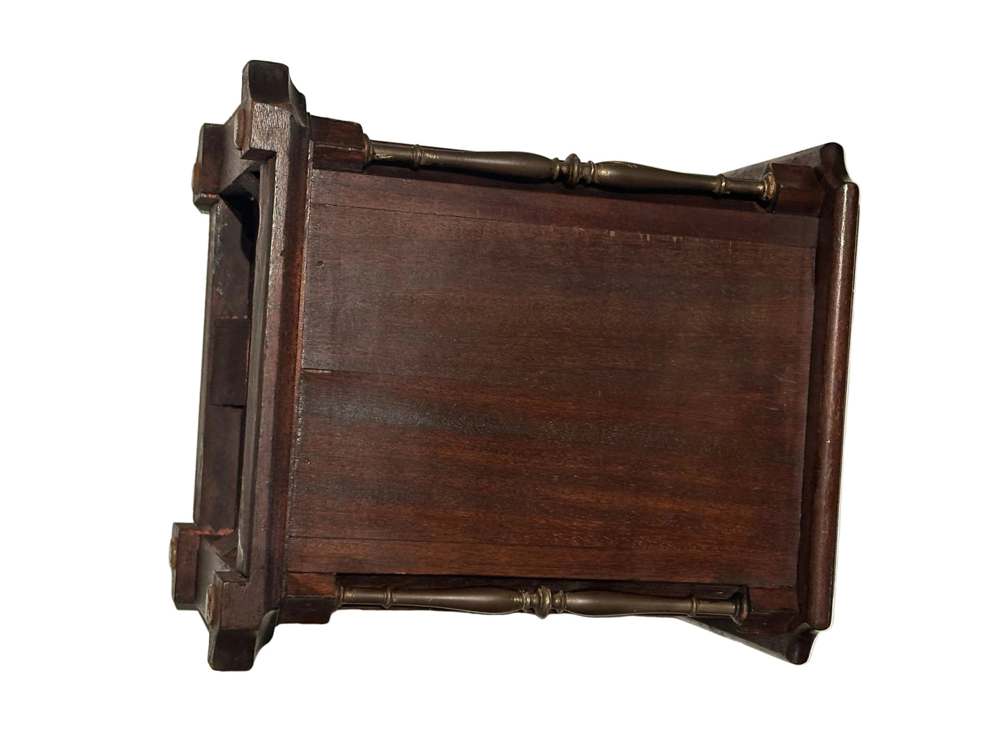 Underside of mahogany umbrella stand showing planked base and turned corner spindles