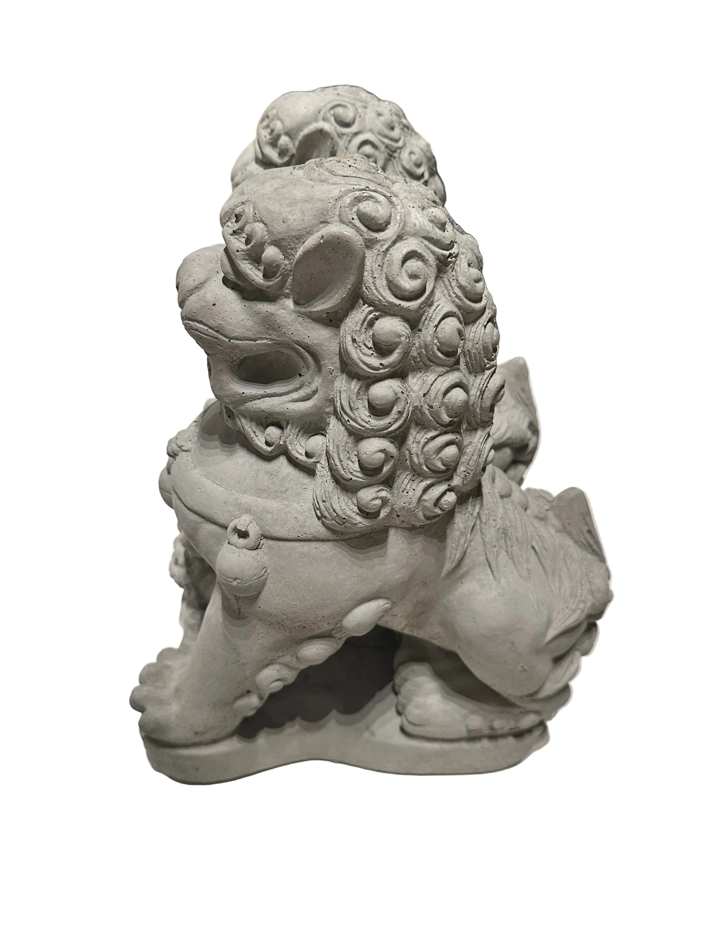Side view of a cast concrete Foo dog showing curled mane and seated pose