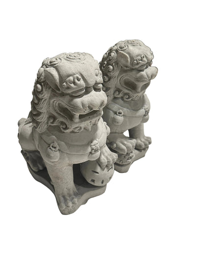 Angled view of the pair of cast concrete Foo dogs, seated guardian lions