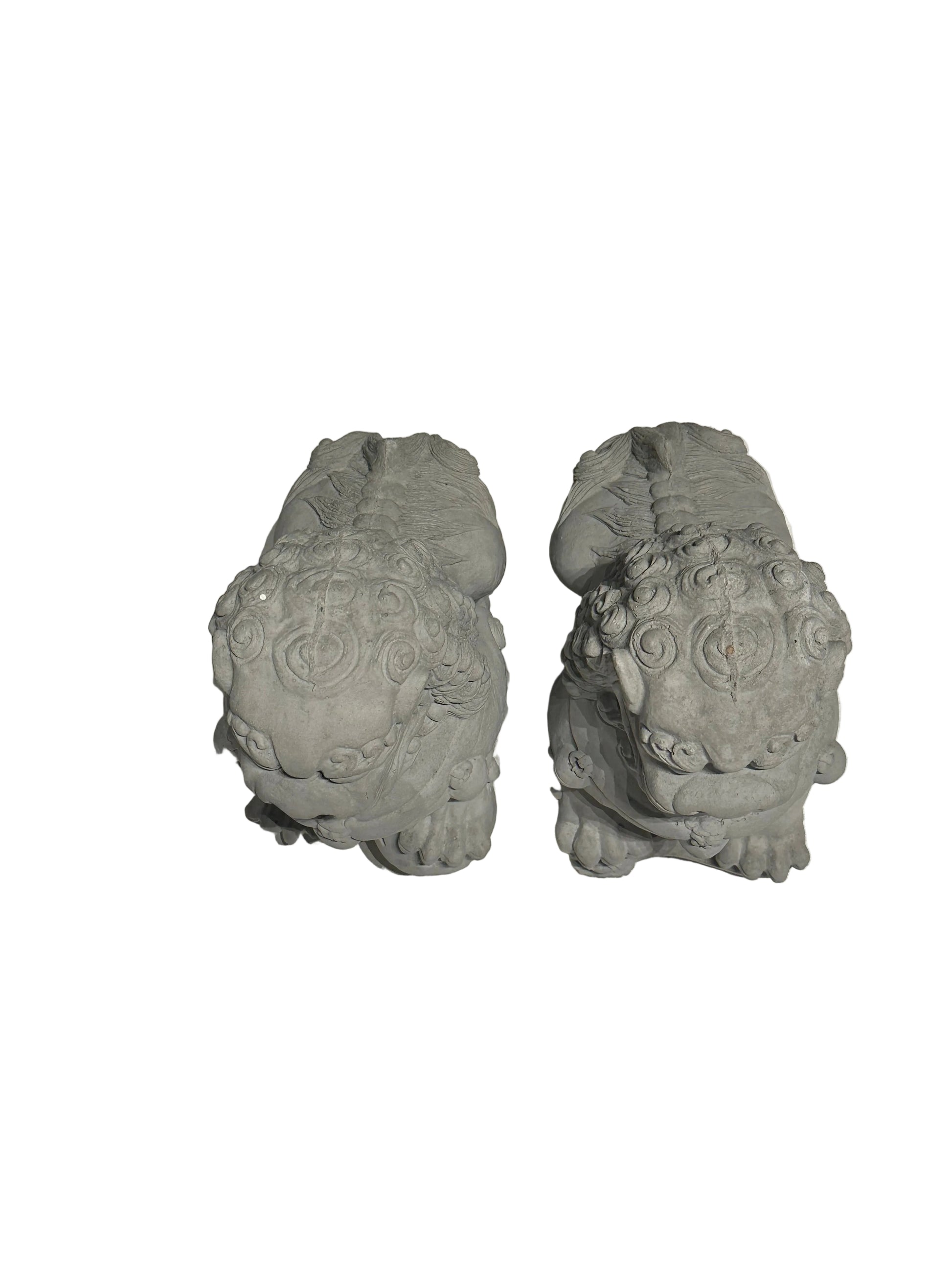 Rear view of the pair of cast concrete Foo dogs showing carved manes