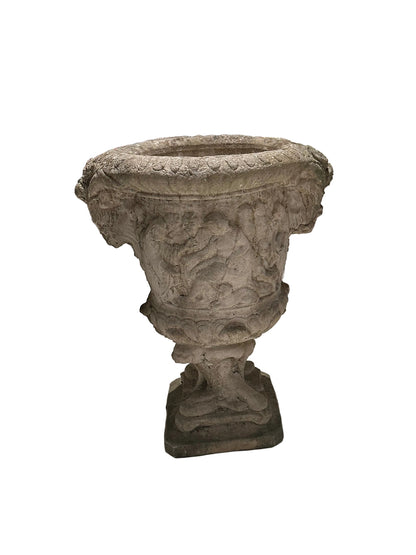 Full three-quarter view of concrete Regency urn with figural relief on square base