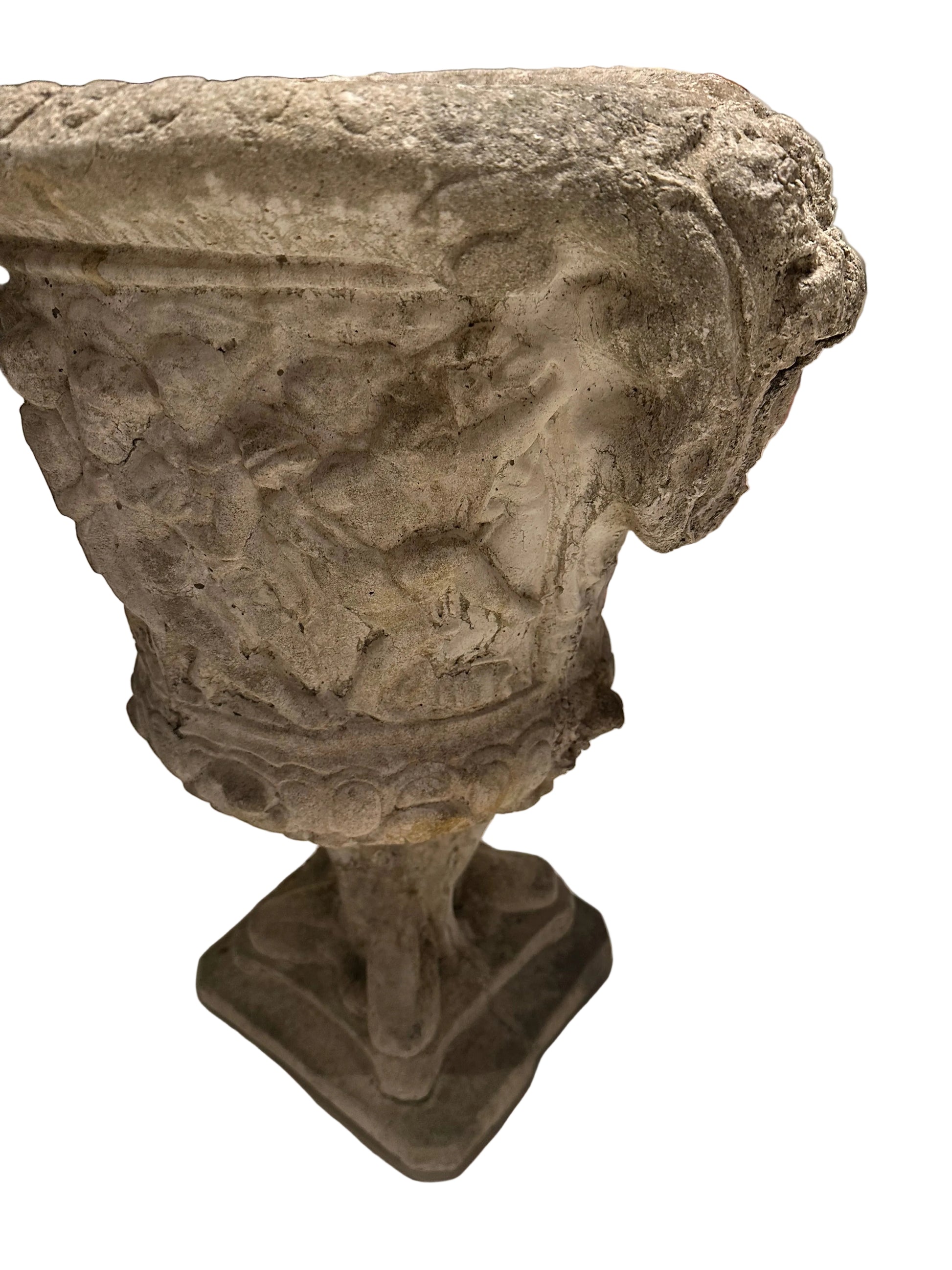 Close-up of concrete Regency urn's figural relief body and egg-and-dart rim