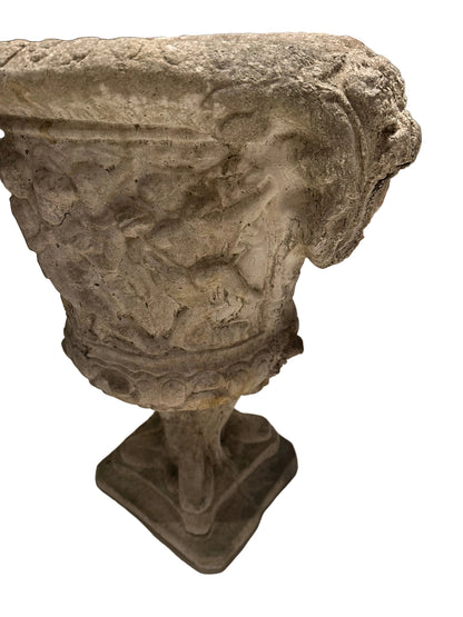 Close-up of concrete Regency urn's figural relief body and egg-and-dart rim