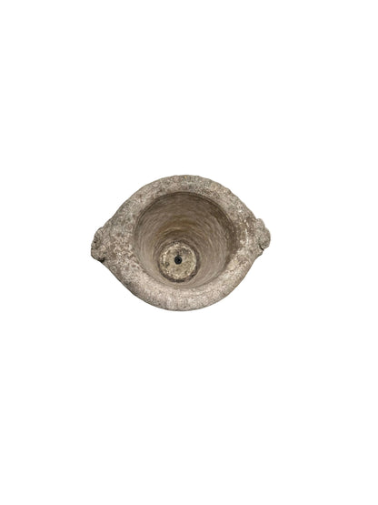 Top-down view of concrete urn rim with central drainage hole