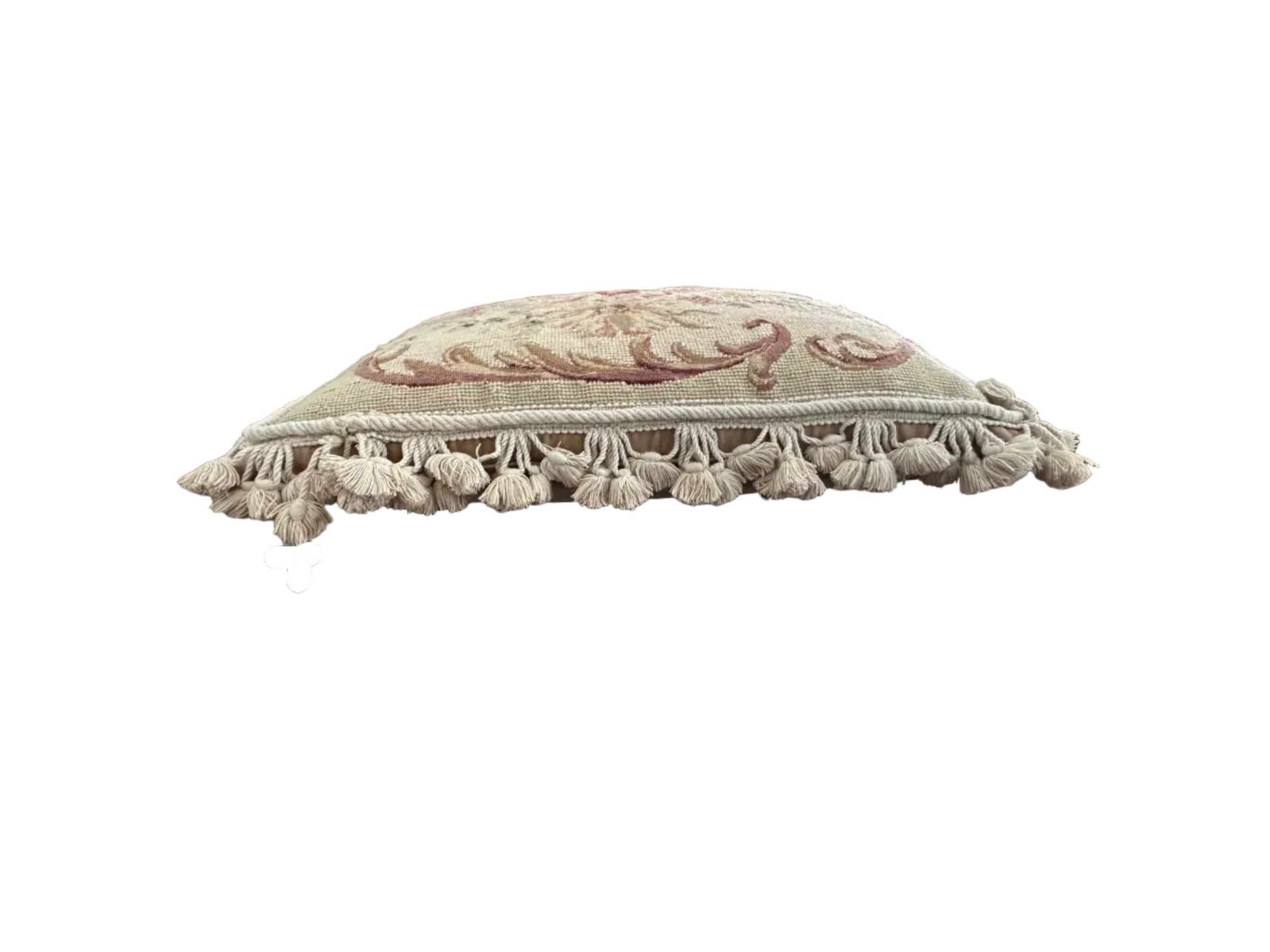 Side profile of needlepoint pillow showing acanthus scroll and tassel fringe