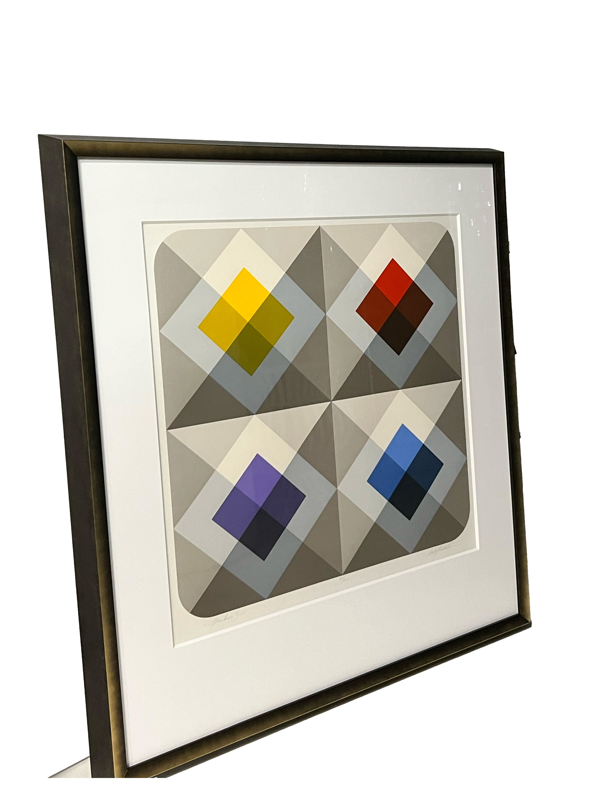 Framed geometric lithograph with four colored diamond squares, angled view