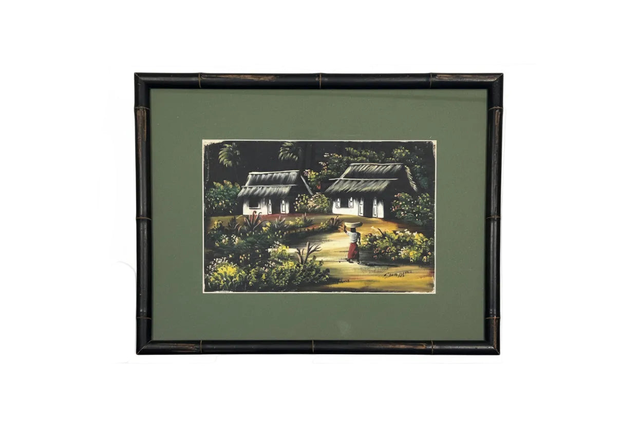 Framed vintage tropical painting of thatched cottages and a woman carrying a basket, dark bamboo frame, green mat