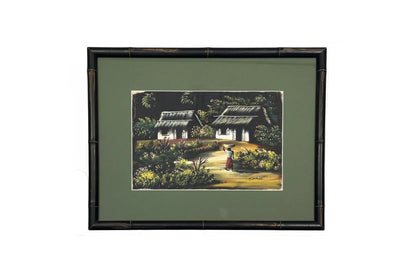 Framed vintage tropical painting of thatched cottages and a woman carrying a basket, dark bamboo frame, green mat