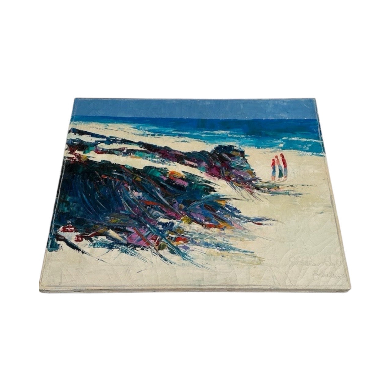 Angled view of the unframed coastal beach oil painting showing thick impasto and canvas edge