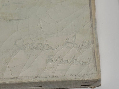 Close-up of the canvas corner showing the artist's signature scratched into the painted edge