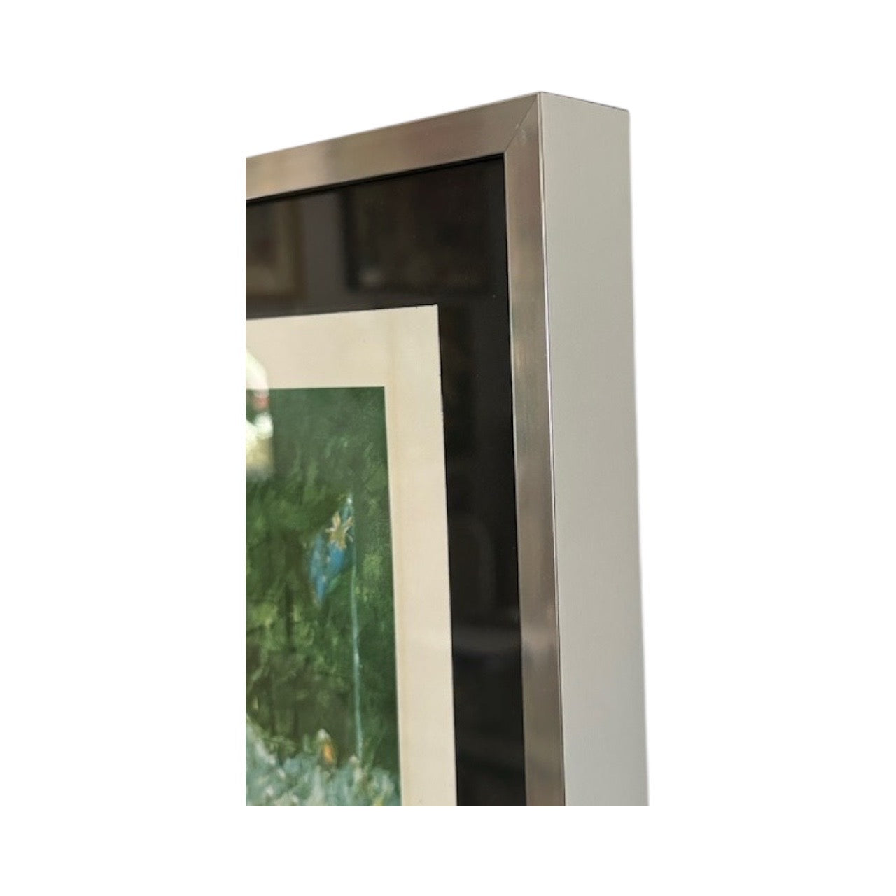 Side-profile detail of the tennis print's brushed silver float frame corner