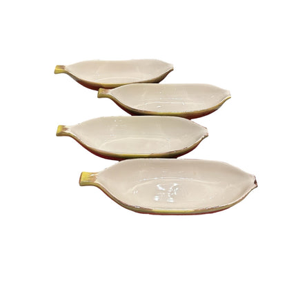 Set of four vintage yellow banana-shaped ceramic split bowls, glossy cream interiors, arranged in a stepped row.