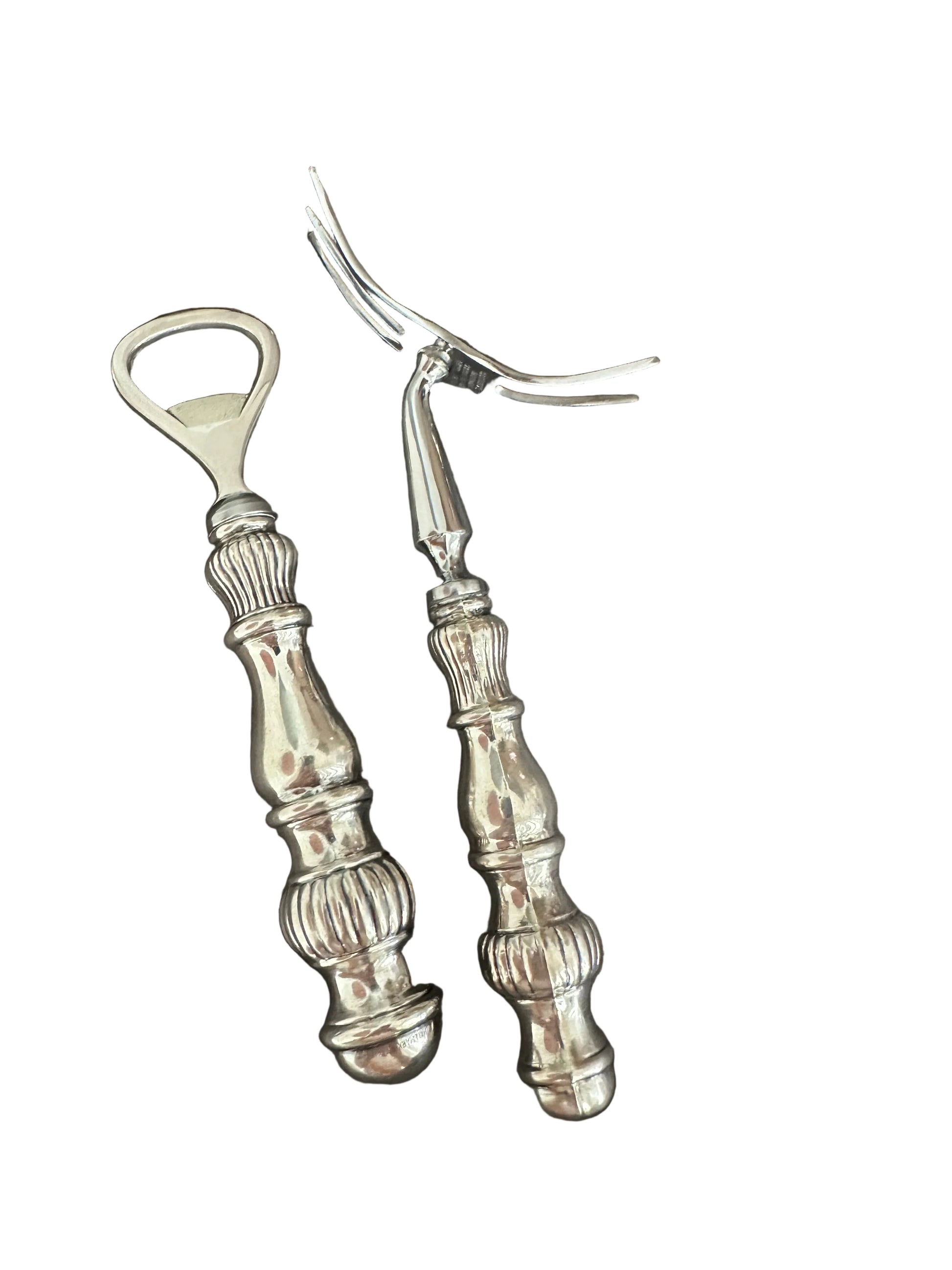 Vintage sterling fluted bar tools standing upright, bottle opener and cocktail fork heads up.