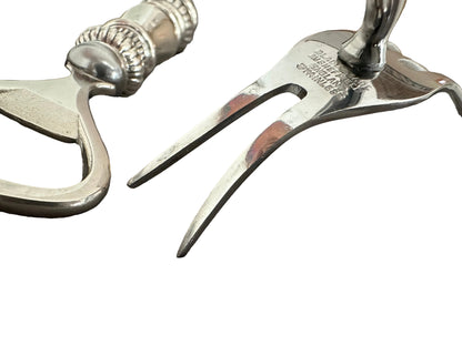 Close-up of bar tool heads, opener and fork tines marked 'Blade made in Sheffield England Stainless'.
