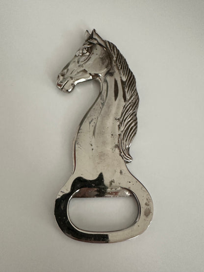 Vintage silver plate horse-head bottle opener showing facial detail and opener notch.