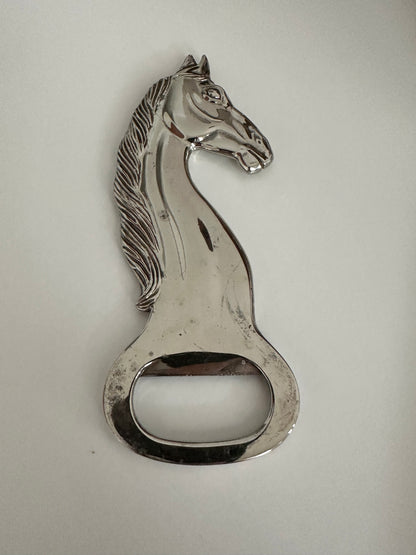 Vintage silver plate horse-head bottle opener, detailed view of mane and bottle-cap lifter.