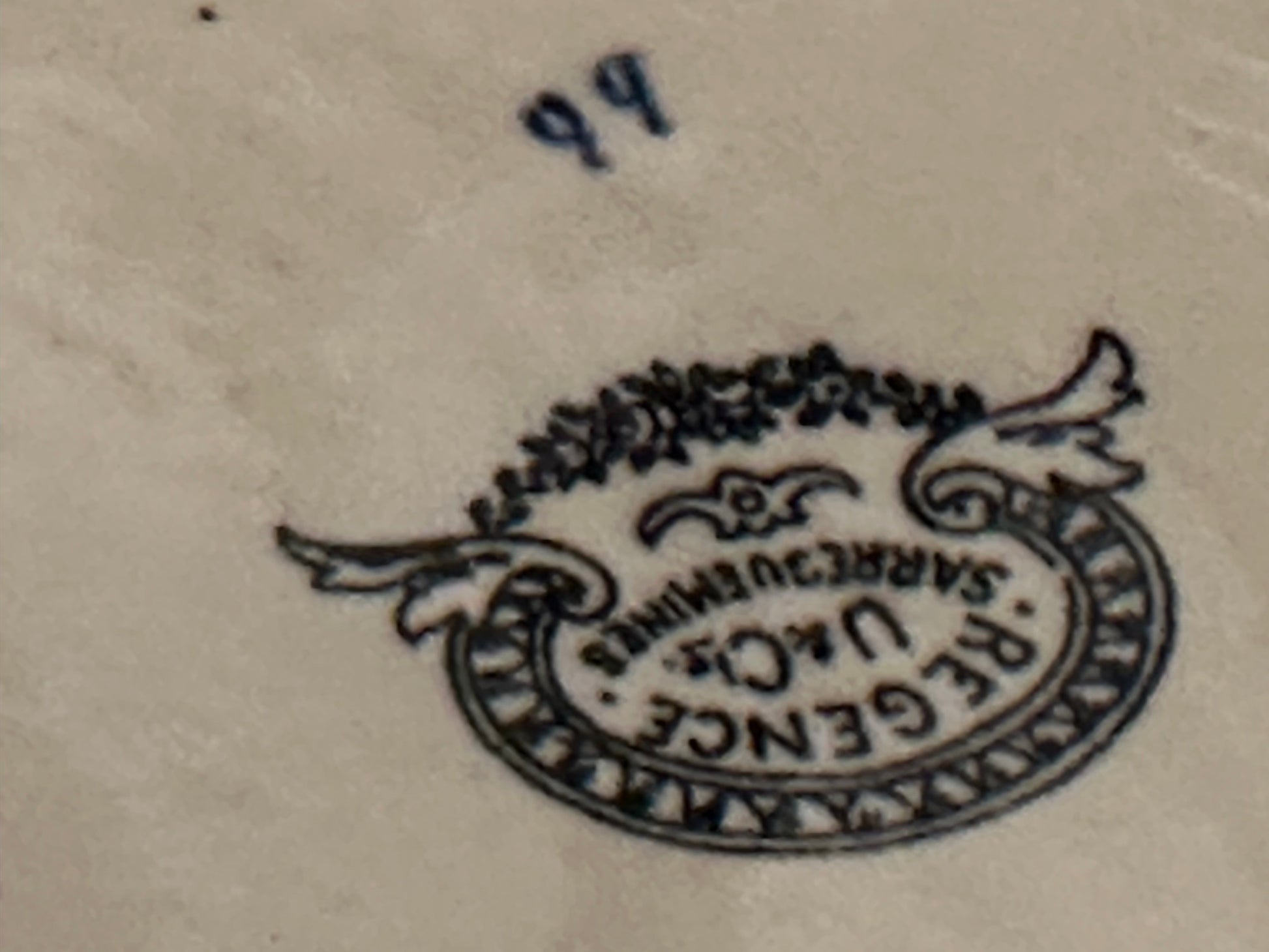 Close-up of the Regence U&Cie Sarreguemines maker's mark on the bowl underside