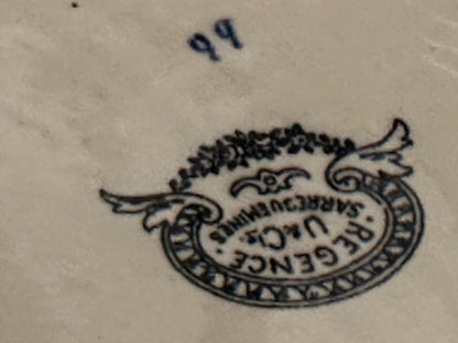 Close-up of the Regence U&Cie Sarreguemines maker's mark on the bowl underside