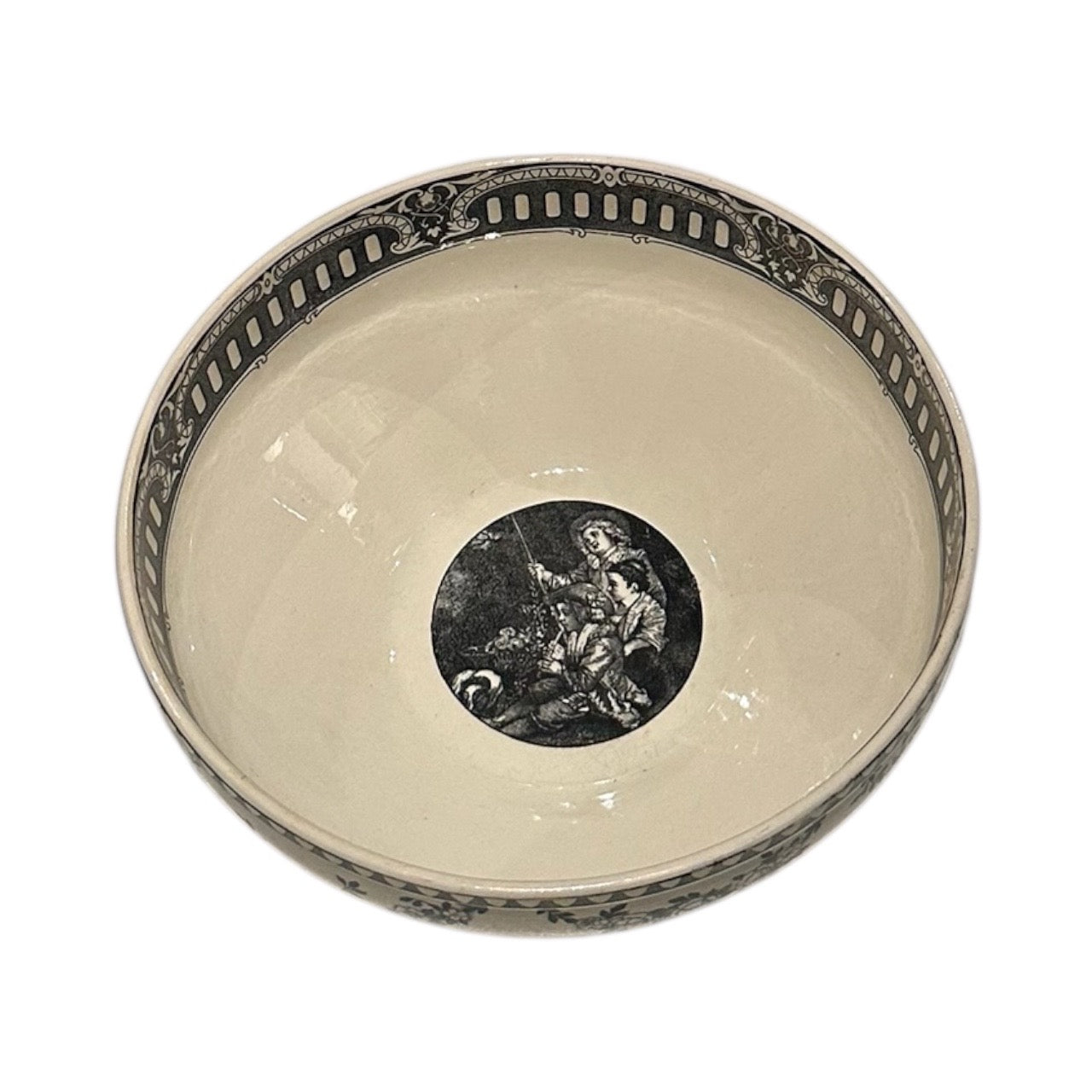 Angled interior view of black transferware bowl showing central scene and pierced-style rim band