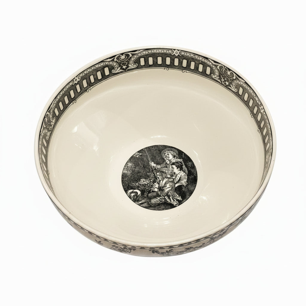 Top-down view inside French black transferware bowl with central figural scene and border band