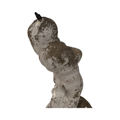Side view of weathered concrete female figure with peeling white paint