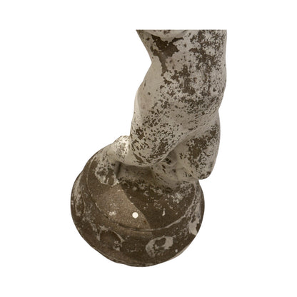 Close-up of the lower legs and round pedestal base of the concrete fountainhead figure