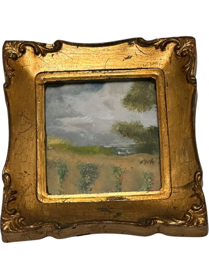 Italian gilt-framed miniature landscape painting, angled view showing ornate scrolled gilt frame