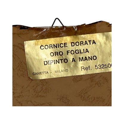 Close-up of Italian frame's back label reading Cornice Dorata Oro Foglia Dipinto a Mano, Canetta Milano