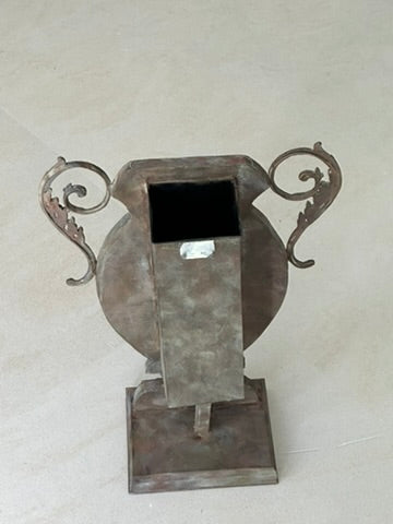 Mirrored urn vase shown on a tiled floor, square opening visible at top