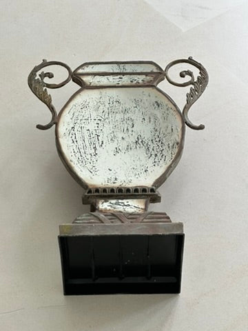 Antiqued mirror urn vase front view on tile, distressed silvered finish and scroll handles
