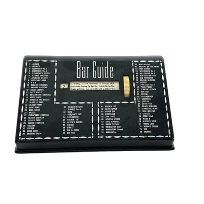 Vintage MCM black Bar Guide cocktail recipe selector, top view showing recipe window set to no. 7