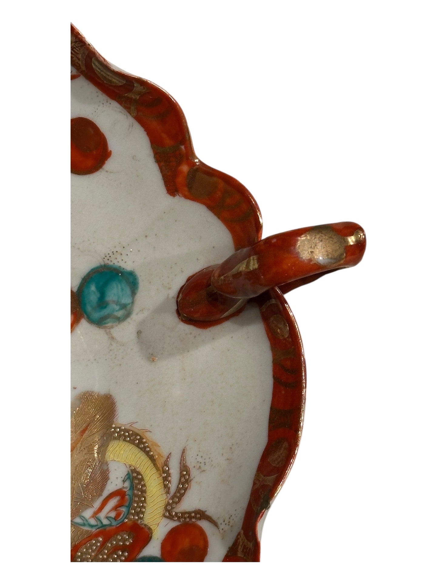 Japanese Kutani porcelain dish, side detail of scalloped red rim and pierced loop handle