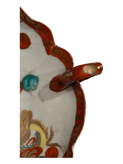 Japanese Kutani porcelain dish, side detail of scalloped red rim and pierced loop handle