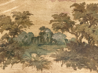 Detail of a painted tabletop depicting a wooded landscape with distant ruins.