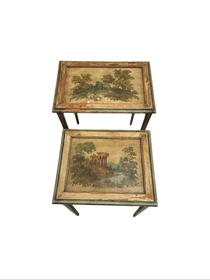 Pair of antique Venetian-style nesting tables with hand-painted pastoral landscape tops under glass.