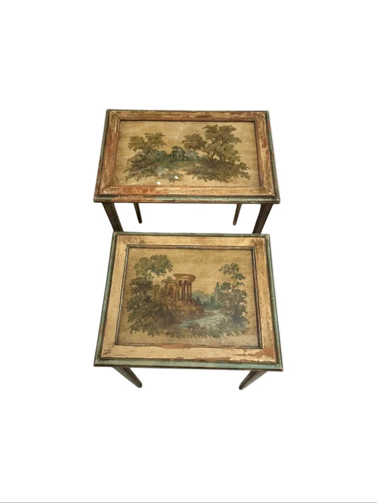 Pair of antique Venetian-style nesting tables with hand-painted pastoral landscape tops under glass.