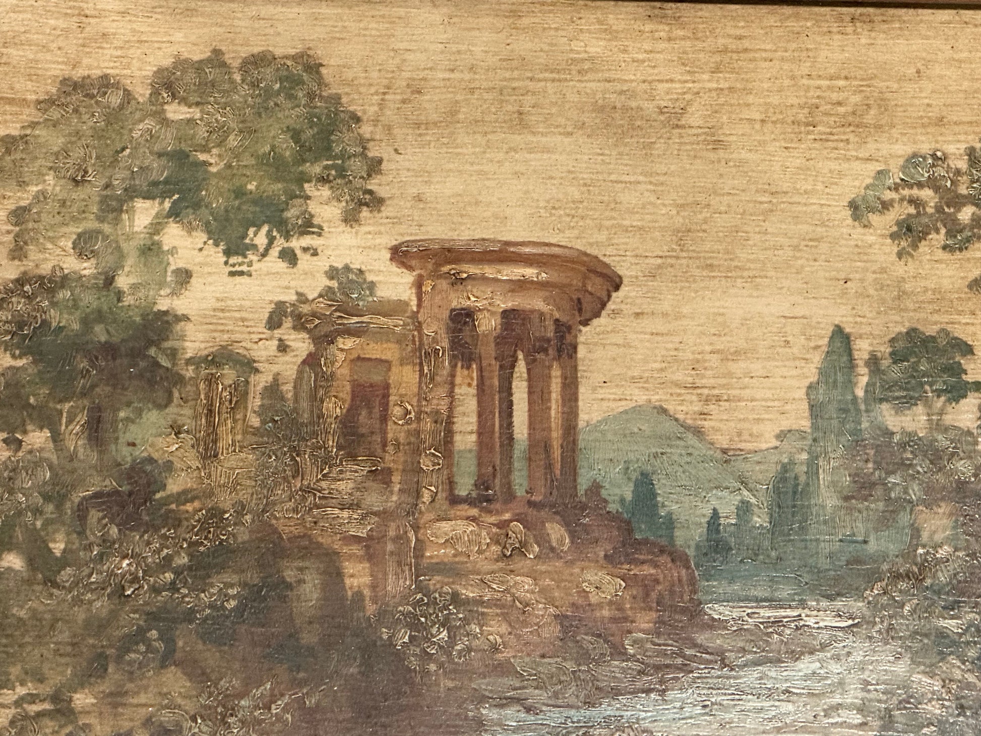 Close-up of hand-painted tabletop scene: a domed classical temple ruin beside a river and mountains.