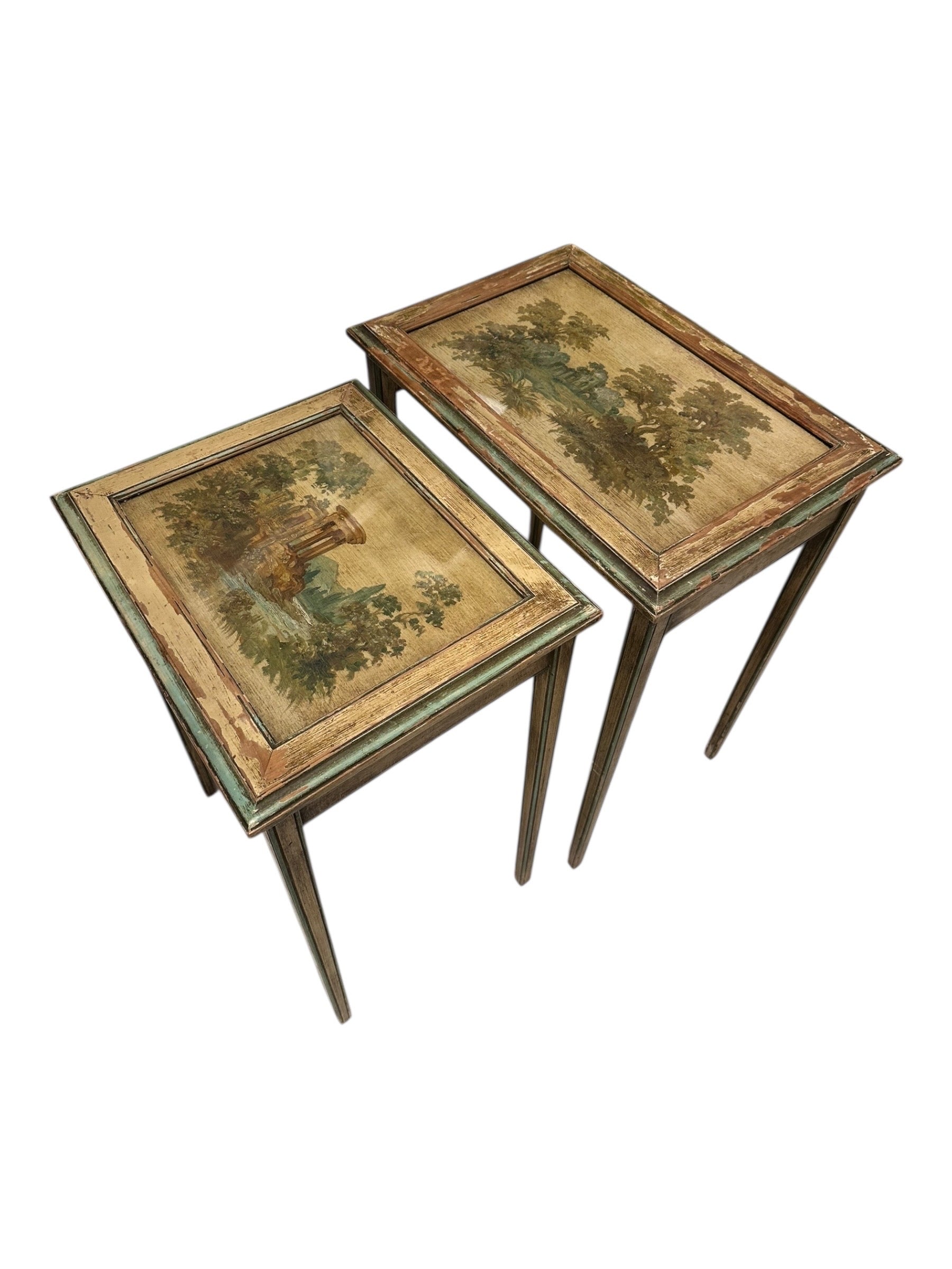 Two Venetian-style nesting tables at an angle, showing distressed green-painted tapered legs.